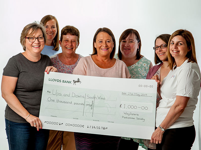 Wayfarers Pantomime Society present cheque to Ups and Downs Southwest